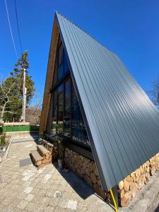 a building with a metal roof on top at Cottage "Sunset" in Batumi