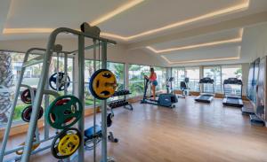 a woman is in a gym with some equipment at Holiday Garden Resort in Okurcalar