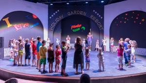 a group of children on the stage at a concert at Holiday Garden Resort in Okurcalar