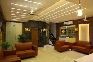 a waiting room with two chairs and a ceiling at Mount Grande "formerly known as Miot Grande" in Chennai