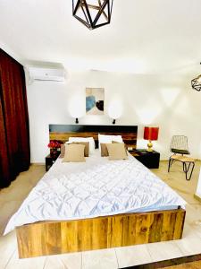 a bedroom with a large bed with a wooden headboard at Hotel Lagadin in Ohrid