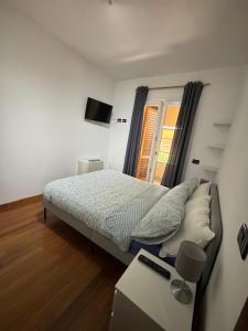 a small bedroom with a bed and a window at Vespucci Rooms & Apartament Eliana SELF CHECK-IN in Florence