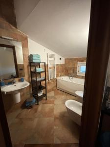 a bathroom with a tub and two sinks and a bath tub at Vespucci Rooms & Apartament Eliana SELF CHECK-IN in Florence