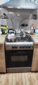 a stove with two pots and pans on top of it at The Friends in Kutaisi