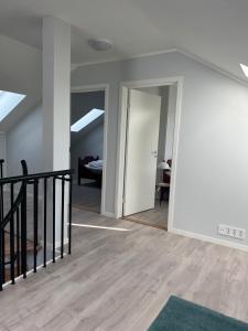 a living room with a staircase and a room with a ceiling at Mosjøen Romutleie EGEDESGATE 49 in Mosjøen