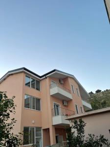 an apartment building with a balcony on top of it at Vila Ornela in Shëngjin