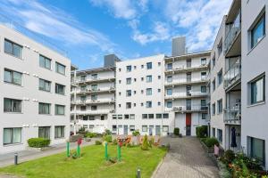 an apartment building with a yard in front of it at Olav in Kristiansand