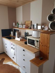 a kitchen with a counter with a microwave on it at Privatzimmer "Himmlisch Übernachten" in Neu Isenburg