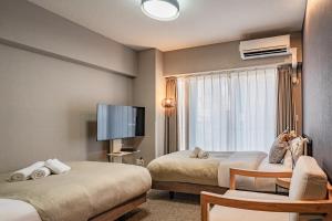 Μια τηλεόραση ή/και κέντρο ψυχαγωγίας στο Apartment Hotel 11 Umeda Kamiyama