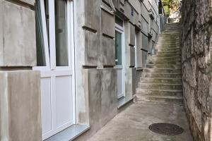 a stairway with a white door and stairs next to a building at Vista Apartment in Opatija