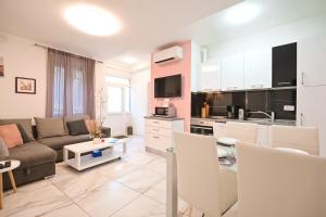 a large living room with a couch and a kitchen at Vista Apartment in Opatija