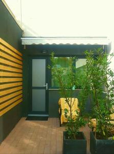 a house with a door and plants in front of it at Luxury Studio in Iaşi