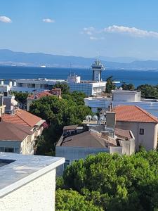 a view of a city with a lighthouse in the distance at Petra Port Hotel in Tuzla