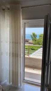 a sliding glass door with a view of a balcony at Vila Ornela in Shëngjin