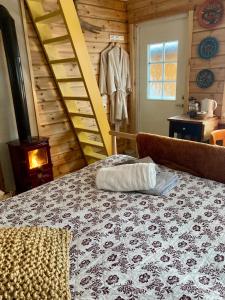 a bedroom with a bed and a ladder and a clothes at Fritt! Bed&Breakfast in Seljord