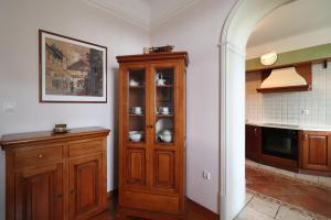 a kitchen with a wooden cabinet and a counter at Apartment Frketić with roof terrace and panoramic sea view in Opatija