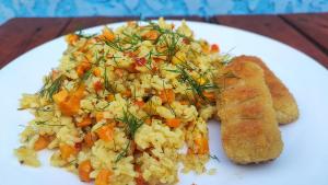 a white plate of food with rice and carrots at The Friends in Kutaisi