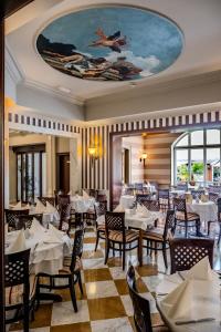 a restaurant with tables and chairs and a ceiling at Amadria Park Hotel Agava in Opatija