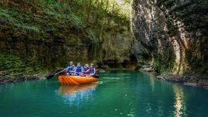 a group of people in a canoe in a river at The Friends in Kutaisi