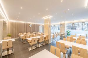 a dining room with tables and chairs in a building at Hotel Barry in Brussels