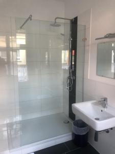 a bathroom with a shower and a sink at Hotel Schwaferts in Wuppertal