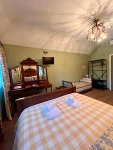 a bedroom with a bed with two towels on it at Hotel Le Ponteil in Antibes