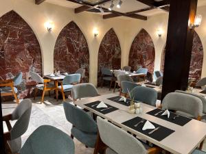 a dining room with tables and chairs and stone walls at Salma Hotel Cairo in Cairo