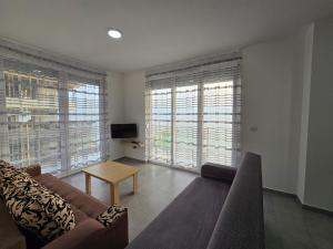 a living room with a couch and a table at Roxhensi 2 in Shëngjin