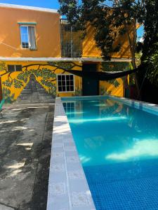 a swimming pool in front of a building at Hotel y Restaurante Casa Jardines in San Benito