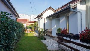 a small yard next to a house with plants at Ivan Apartment Skopje in Skopje