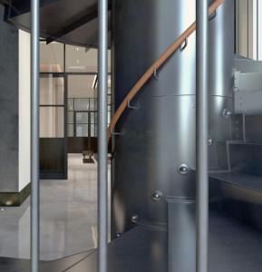 a metal staircase in a building with a steel wall at 11 Howard, New York, a Member of Design Hotels in New York