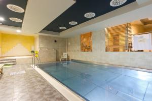 a large swimming pool with a pool at Hotel Janosik in Liptovský Mikuláš