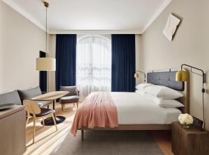 a hotel room with a bed and a table and chairs at 11 Howard, New York, a Member of Design Hotels in New York