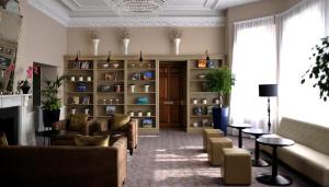 a living room with couches and a fireplace at De Vere Cranage Estate in Holmes Chapel