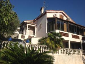 a white house with a palm tree in front of it at La Nectarine in Nice