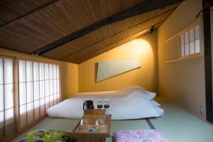 Una cama o camas en una habitación de Ryokan Mugen (Adult Only)