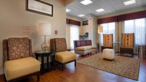 a waiting room with chairs and a table in a room at Best Western Plus O'hare International South Hotel in Franklin Park