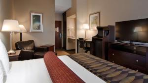 a hotel room with a bed and a flat screen tv at Best Western Plus O'hare International South Hotel in Franklin Park