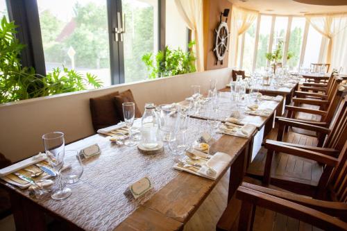 a long table in a restaurant with glasses on it at Villa St. Tropez in Prague