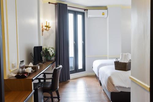 Ein Bett oder Betten in einem Zimmer der Unterkunft The MACEO Hotel