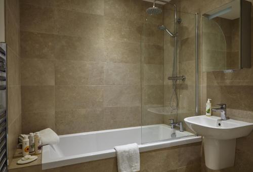 a bathroom with a tub and a sink and a shower at The Loft House - Beautiful House in Best Location in Bath