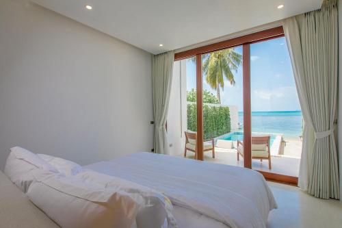 Ein Bett oder Betten in einem Zimmer der Unterkunft White Whale Beachfront Pool Villa