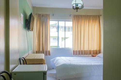 Säng eller sängar i ett rum på Hotel Marsal