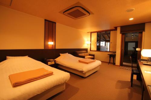 Tempat tidur dalam kamar di Hotel Yumeshizuku