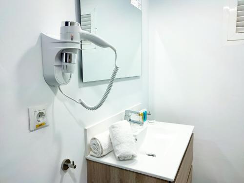 a bathroom with a white sink and a mirror at Hotel Flats Friends Mar Blau in Benidorm