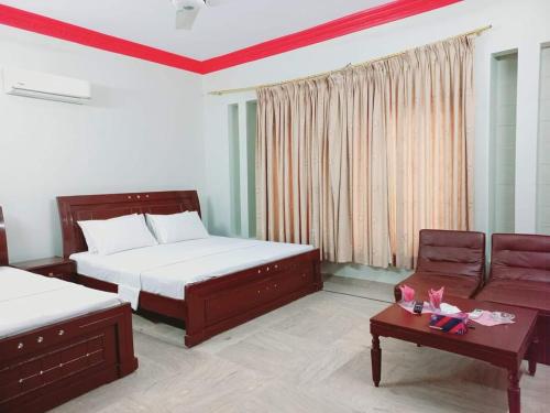 Säng eller sängar i ett rum på Cosy Inn Guest House Karachi