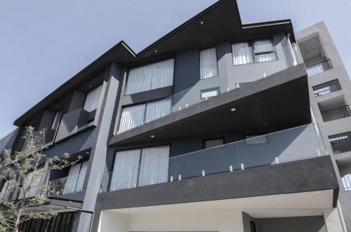 an apartment building with a black facade at CREW Hotel in Chiang Mai