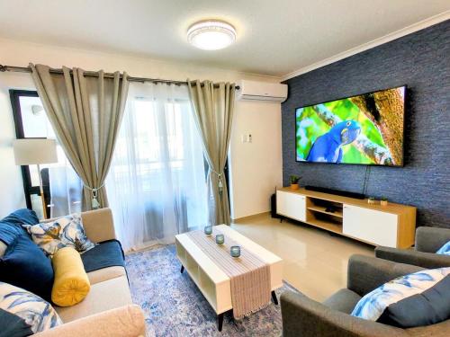 A television and/or entertainment centre at Pristine King Size Bed Apartment In Secure Complex