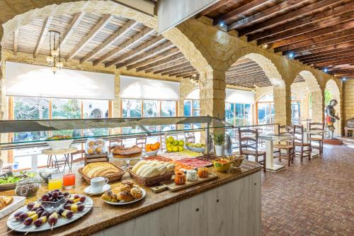 a buffet in a building with a lot of food at Hotel Plaza Del Castillo in Málaga