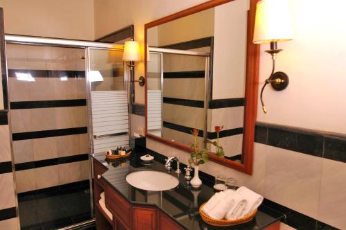 a bathroom with a sink and a mirror at Settha Palace Hotel in Vientiane